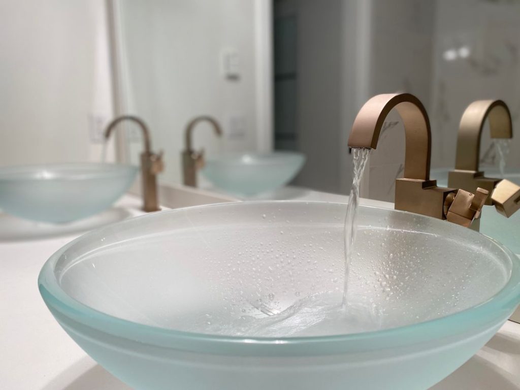 Renovated ensuite with double vanity. Newly installed glass sinks with Delta Faucets.