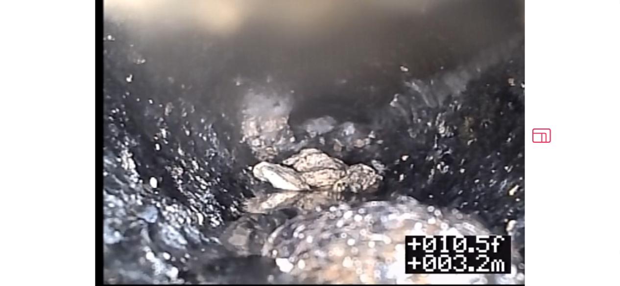 Drain camera footage showing debris and blockage inside pipe before cleaning, commercial plumbing in Abbotsford
