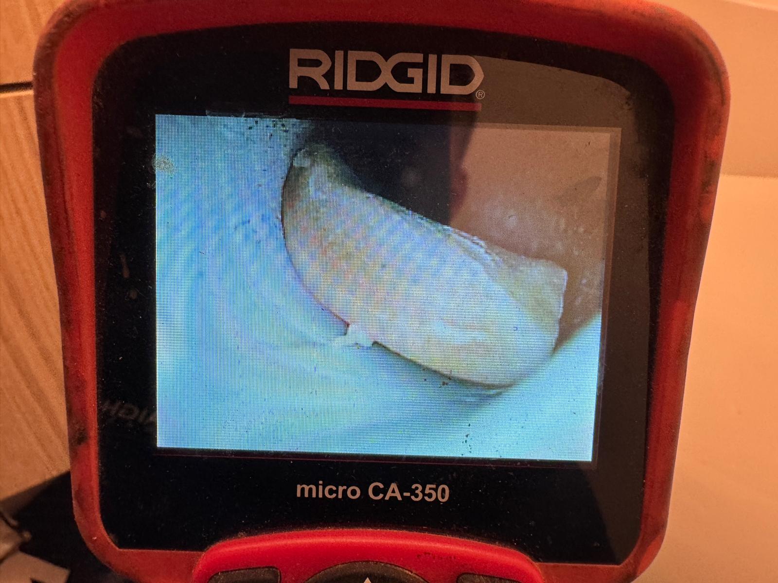 Ridgid camera monitor screen showing sponge wedged inside drain line, drain cleaning in Coquitlam