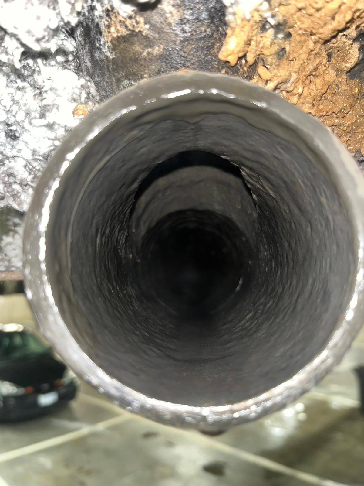 Clean drain pipe interior after hydro jetting in parkade, commercial plumbing in Coquitlam