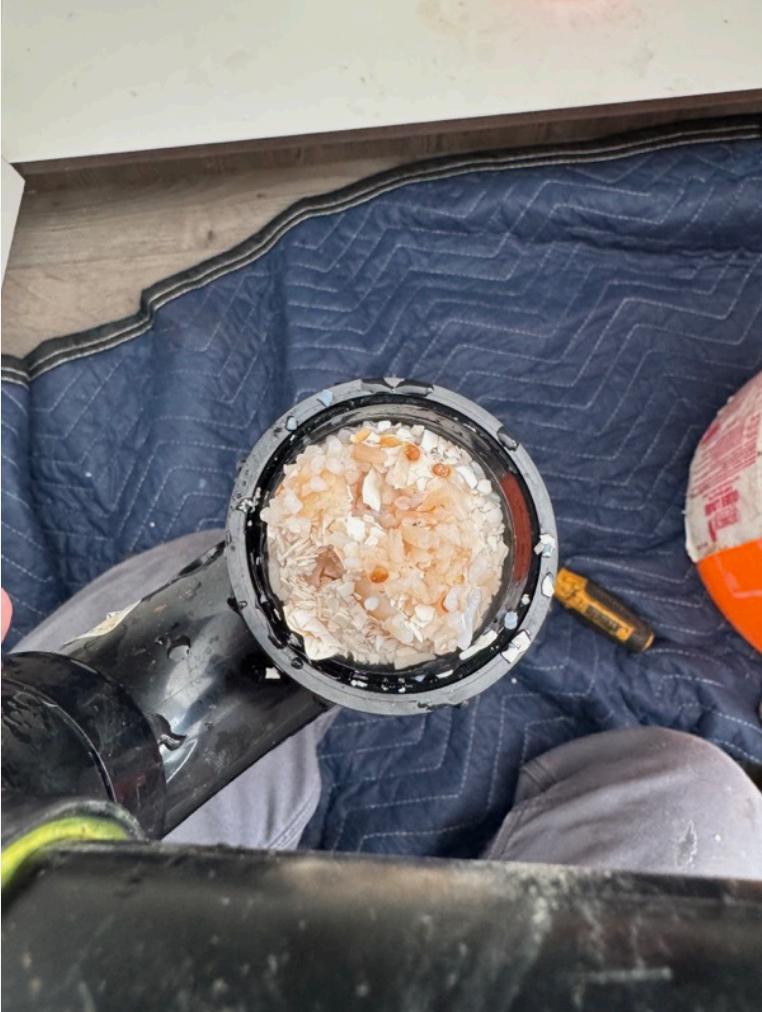 debris buildup inside pipe trap - work blanket on floor
