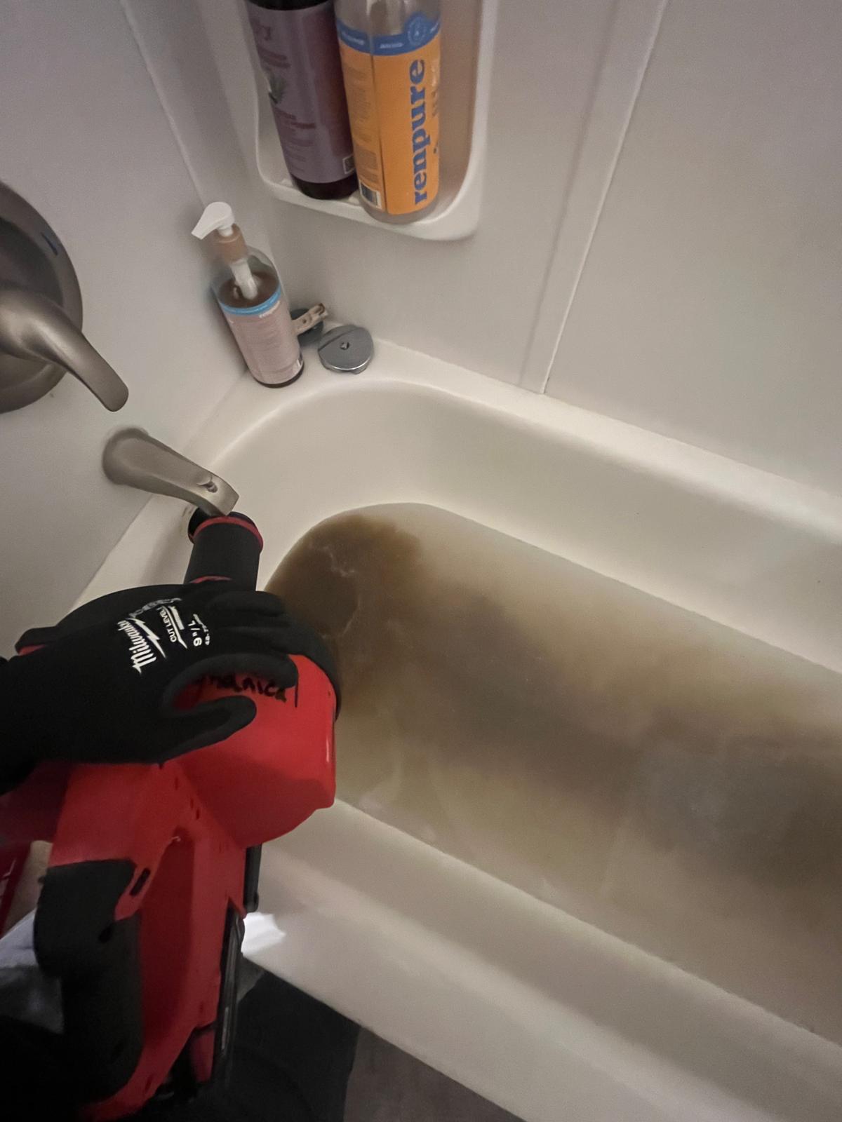 Debris extracted from shared apartment drain during commercial plumbing in Abbotsford