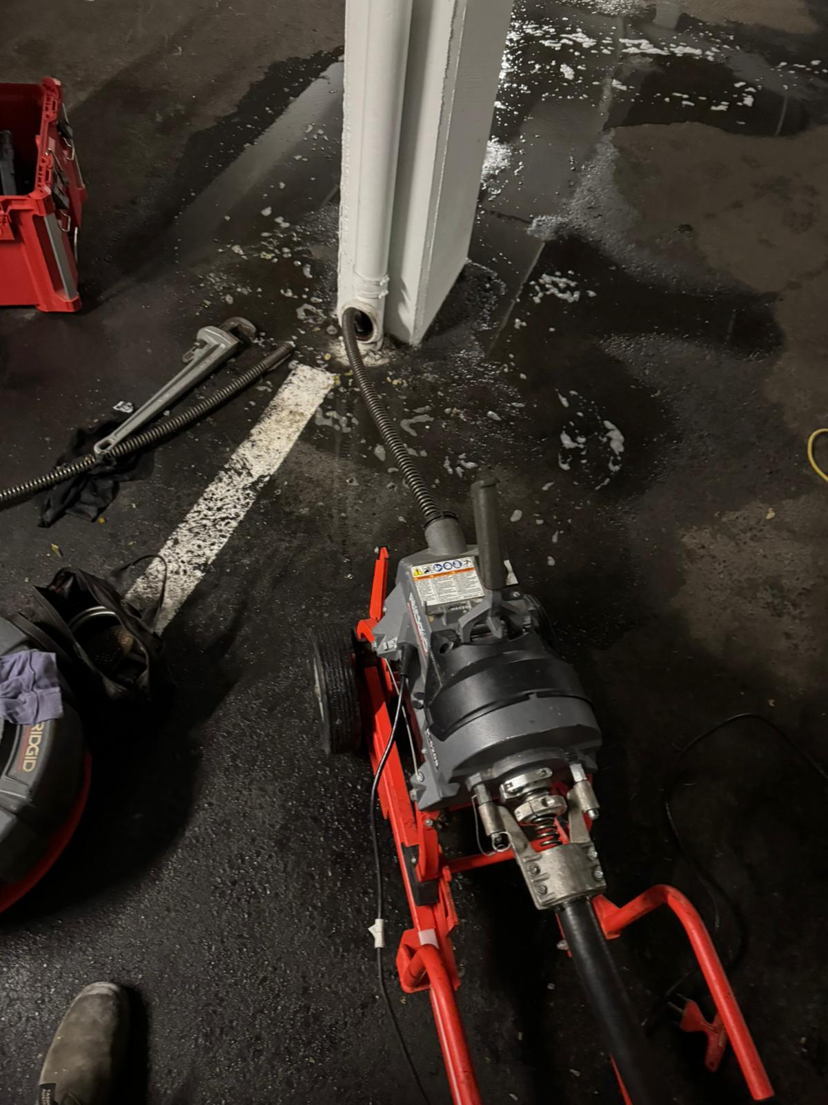 Large powered drain snake machine set up in parkade cleanout, commercial plumbing in Abbotsford