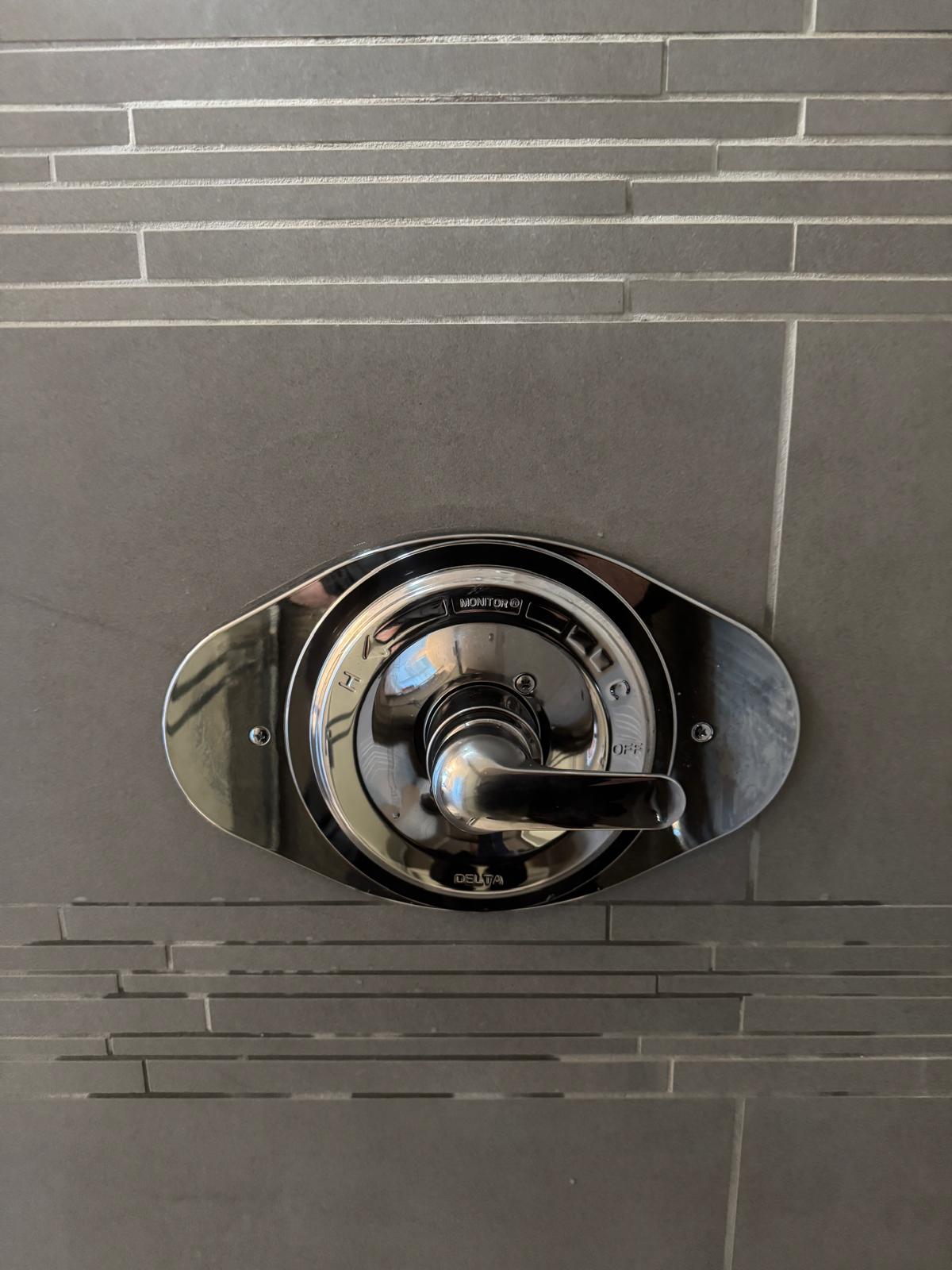 New shower valve body installed behind cut tile in Langley for drain cleaning