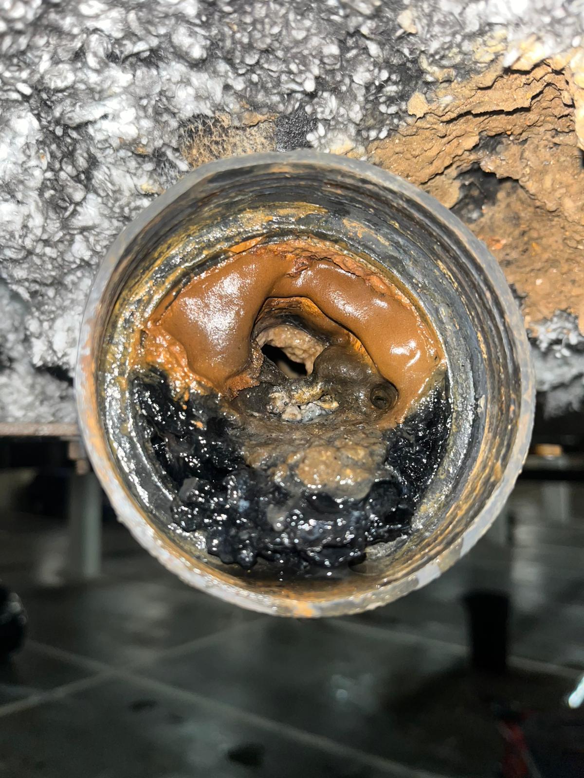 Pipe interior with heavy sediment and buildup before hydro jetting, commercial plumbing in Coquitlam