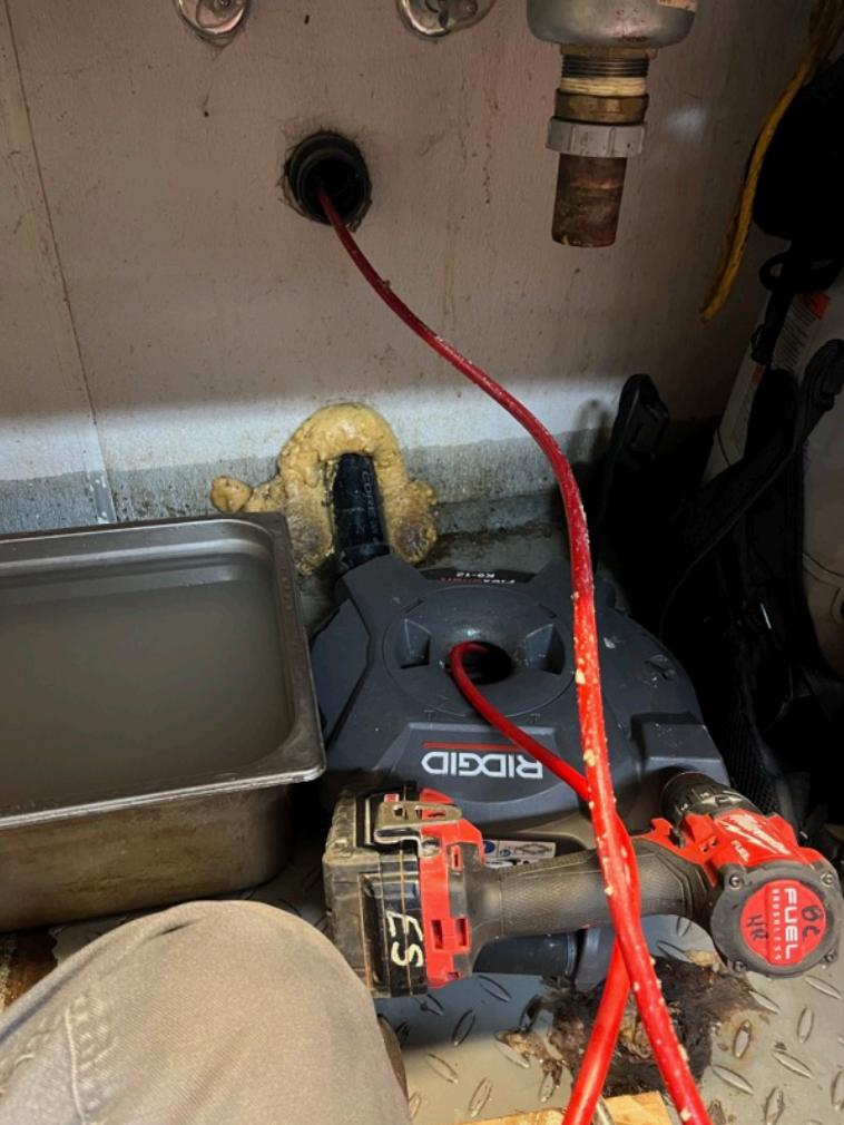 ridgid K-12 drain machine feeding cable into pipe - Maple Ridge Restaurant