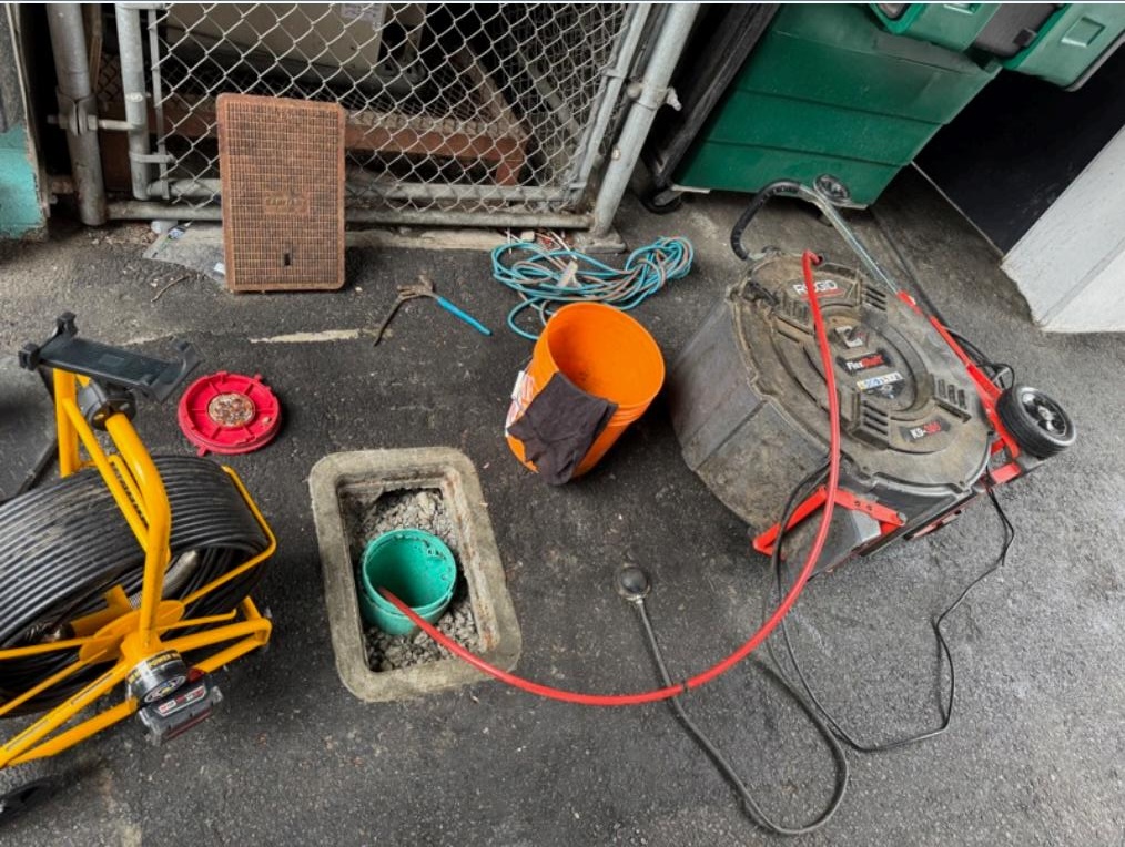 technician carrying out quarterly drain cleaning service in Vancouver