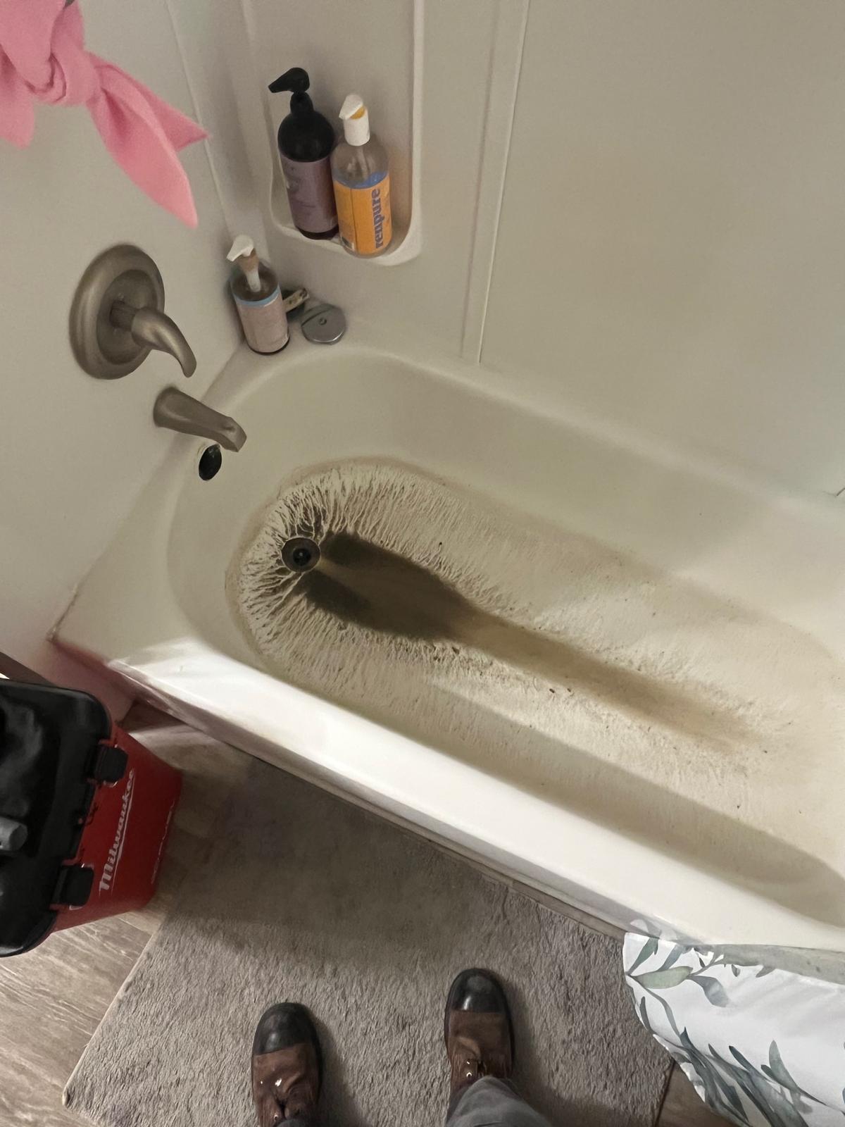Wastewater backing up into bathtub from shared drain clog — commercial plumbing in Abbotsford